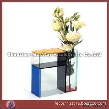 Colorized acrylic vase with a small table aside